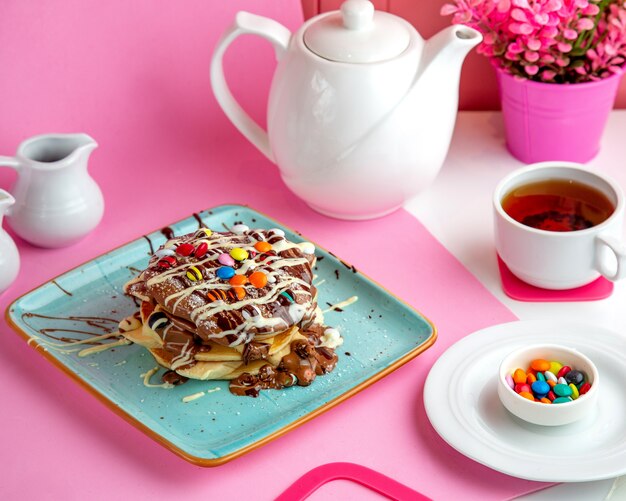 lush pancakes with chocolate and multi-colored candies