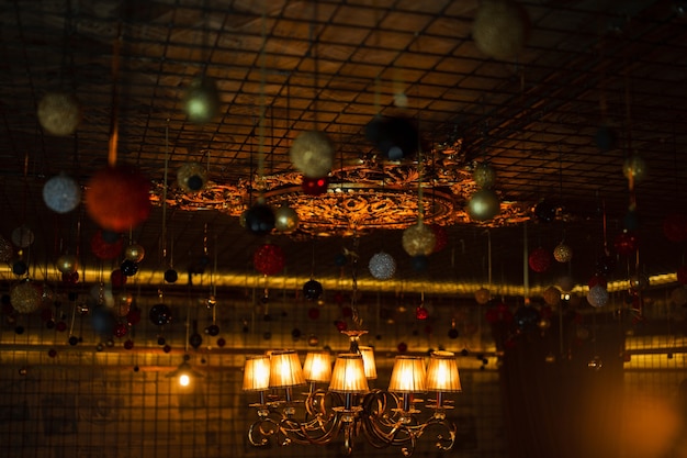 Luxurious amazing stunning beautiful christmas vintage festive ceiling decorated with various colorful lights and garlands. .christmas toys. homely cozy atmosphere. close-up