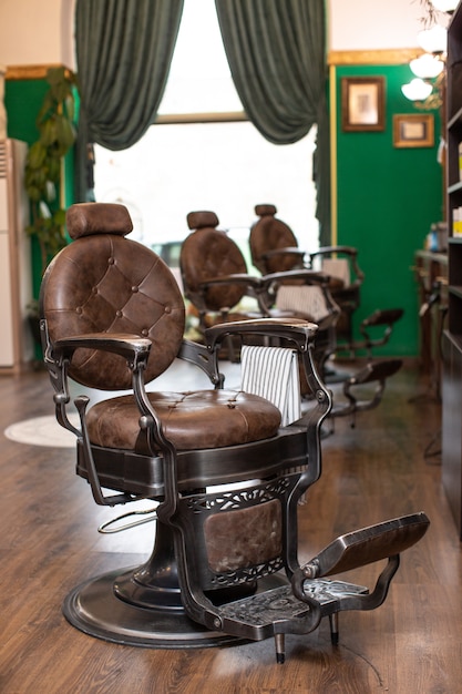 Free photo luxury armchairs in barber shop