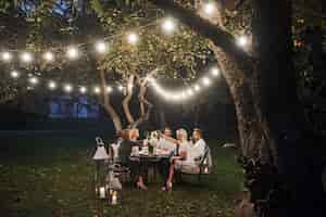 Free photo luxury dinner. evening time. friends have a dinner in the gorgeous outdoor place