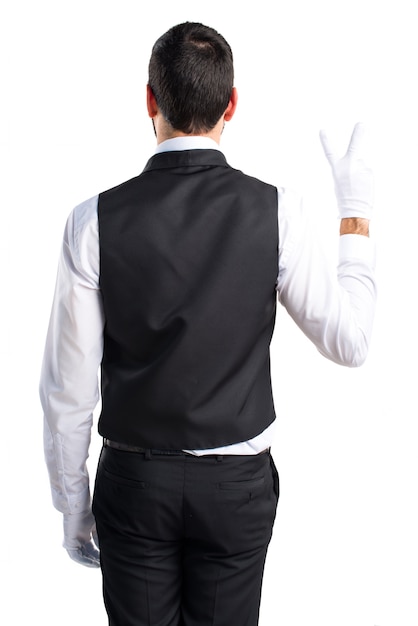 Free photo luxury waiter doing victory gesture