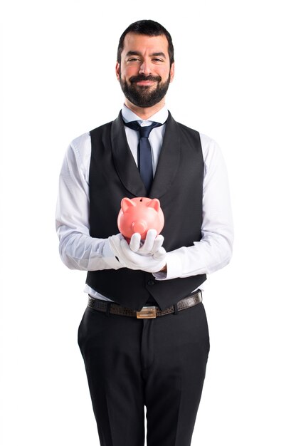 Luxury waiter holding a piggybank