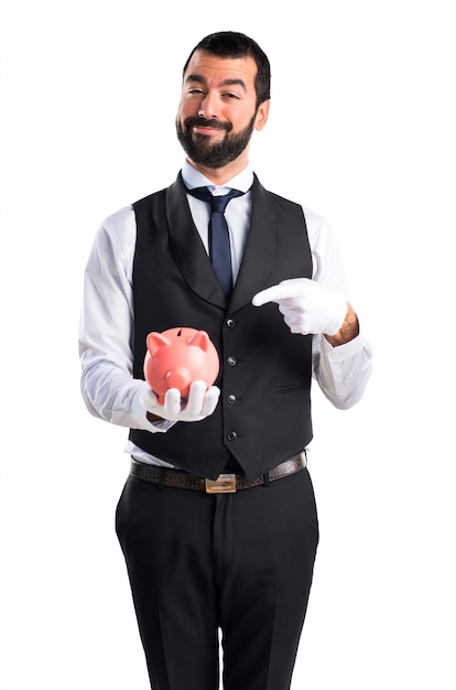 Luxury waiter holding a piggybank