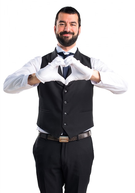 Luxury waiter making a heart with his hands