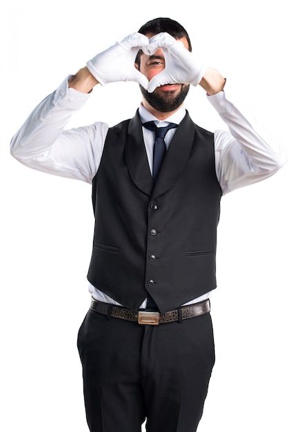 Free photo luxury waiter making a heart with his hands