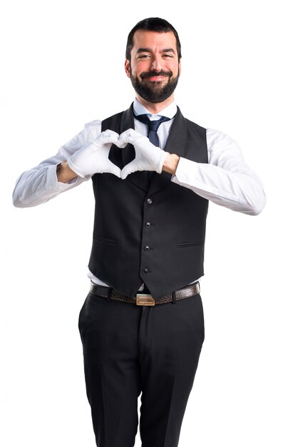 Luxury waiter making a heart with his hands