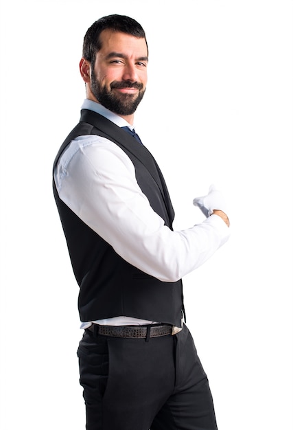 Luxury waiter pointing back