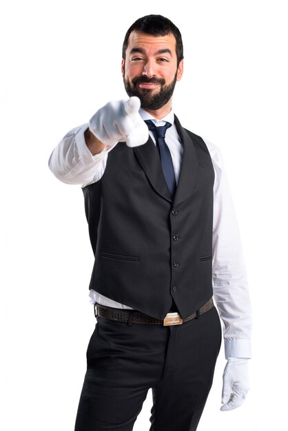 Luxury waiter pointing to the front