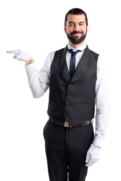 Free photo luxury waiter pointing to the lateral