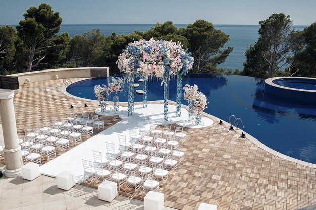 luxury wedding ceremony near the pool and sea