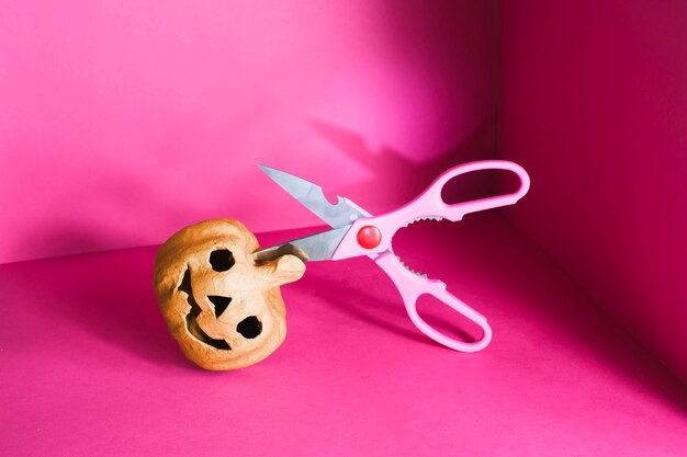 Lying jack-o-lantern with scissors