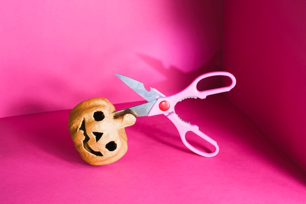 Lying jack-o-lantern with scissors