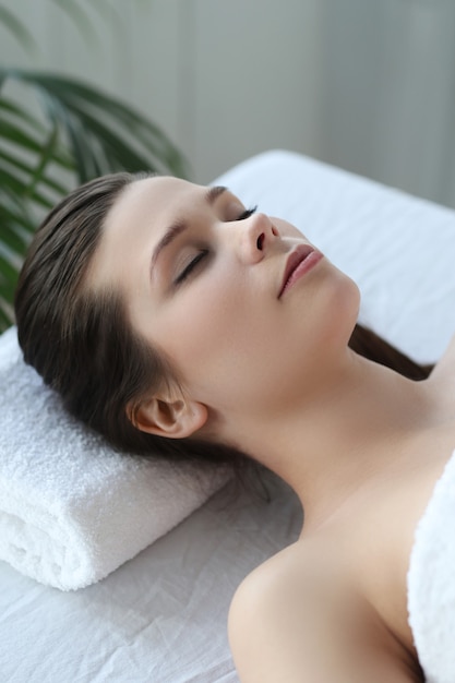 Lying woman prepared to receive a beauty treatment