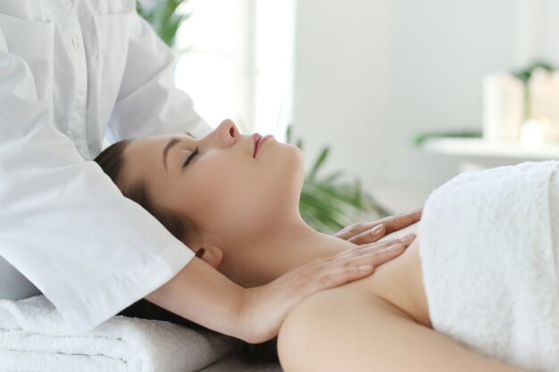 Lying woman receiving a body massage.