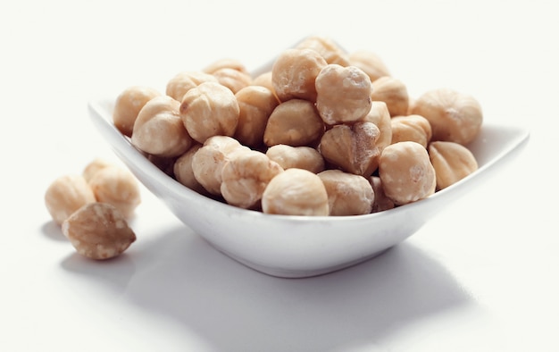 Macadamia nuts on white bowl