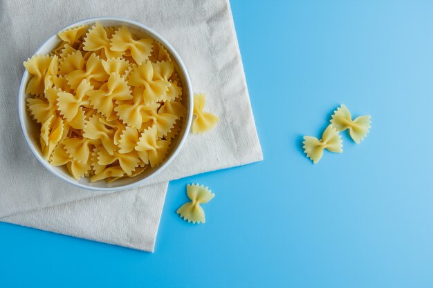 Macaroni pasta in a bowl on a cloth