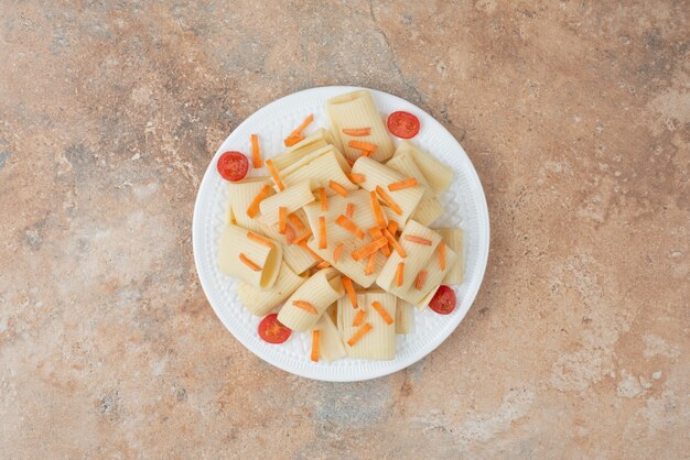 하얀 접시에 당근과 토마토 체리와 마 카로 니.