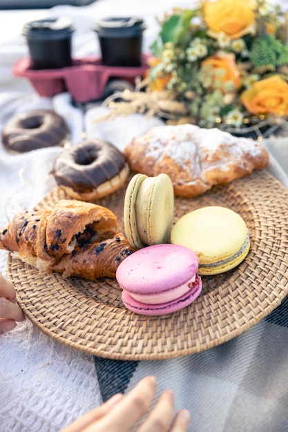 Free photo macaroon croissants and donuts close up picnic concept