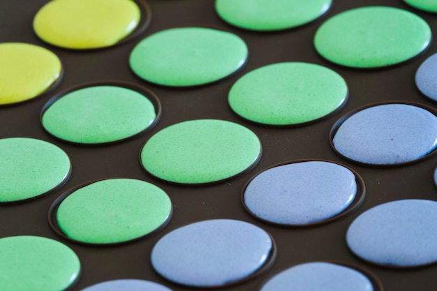 Free photo macaroon mixture in the black baking tray