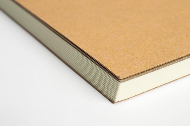 Free photo macro of blank notebook corner with cardboard hardcover isolated on white