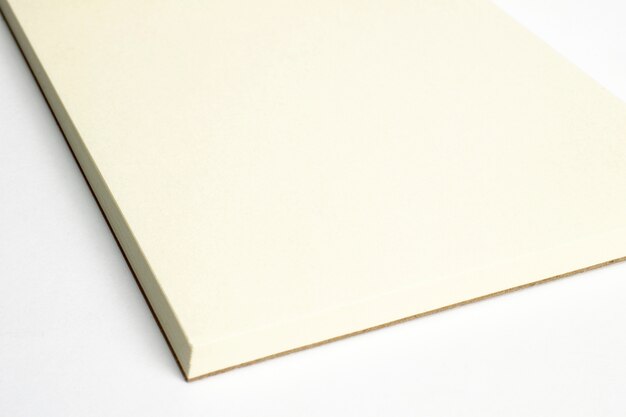 Macro of blank opened notebook corner with cardboard hardcover isolated