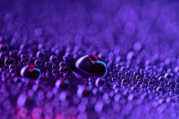 Macro detail of water drop on blue textured background