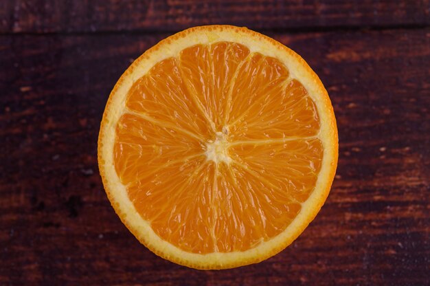 Macro image of ripe orange, on wood table
