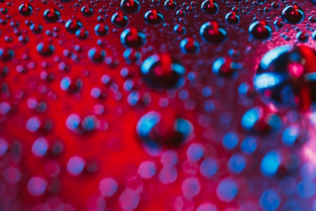 A macro photograph of water droplets on bright background