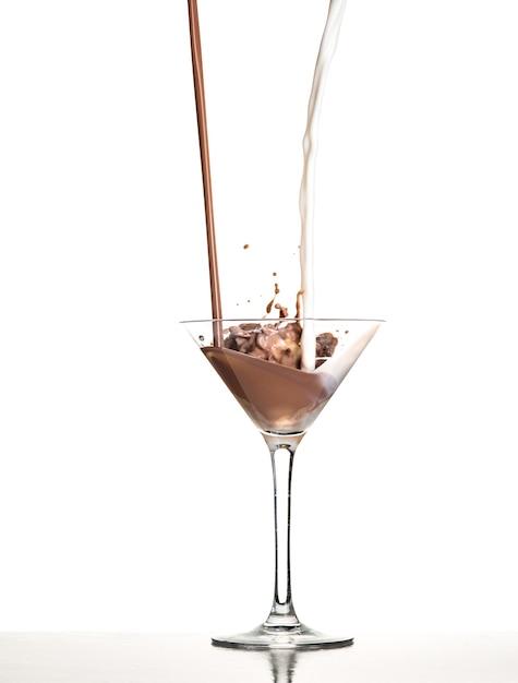 Macro shoot with hot chocolate falling in glass on white in studio
