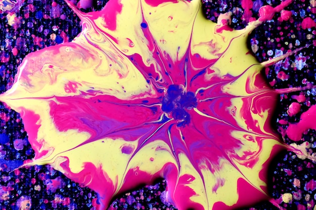 Free photo macro shot of an abstract mixture of colorful acrylic paint splashes on a black background