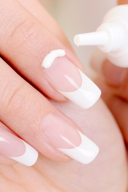 Macro shot of a female index finger with  moisturizing cream on it