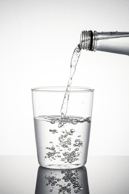 Free photo macro shot of water pouring into a glass