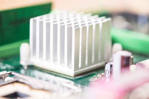 Macro shot of white heatsink on motherboard circuit