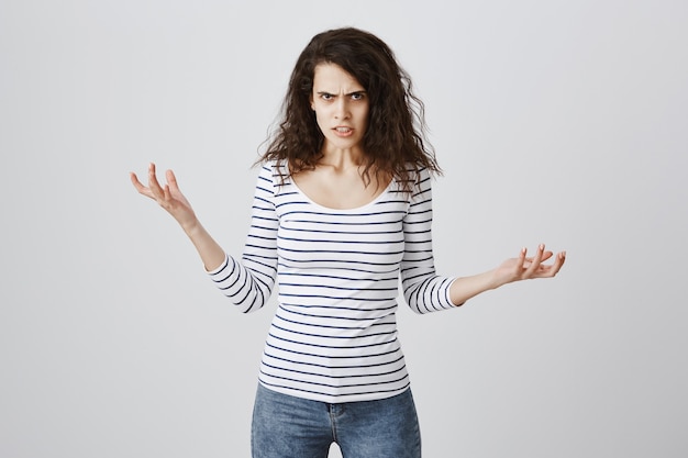 Foto gratuita donna arrabbiata e infastidita che si lamenta, stringe la mano e aggrotta la fronte angosciata