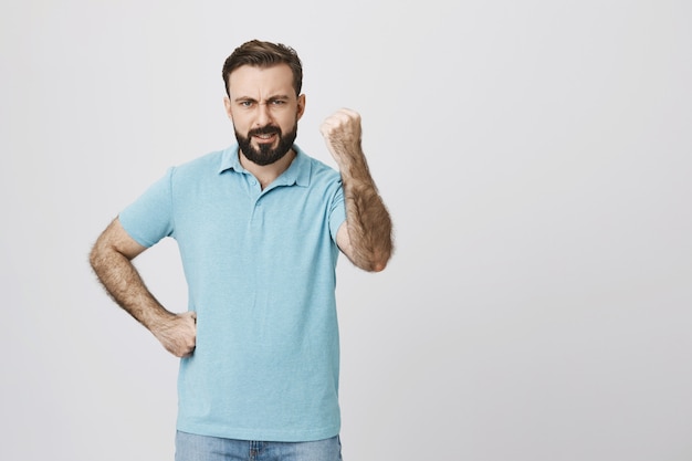 Mad disappointed man shaking fist angry, scolding