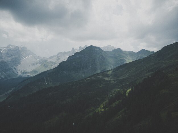 Magnificent mountain covered in snow under the beautiful foggy sky