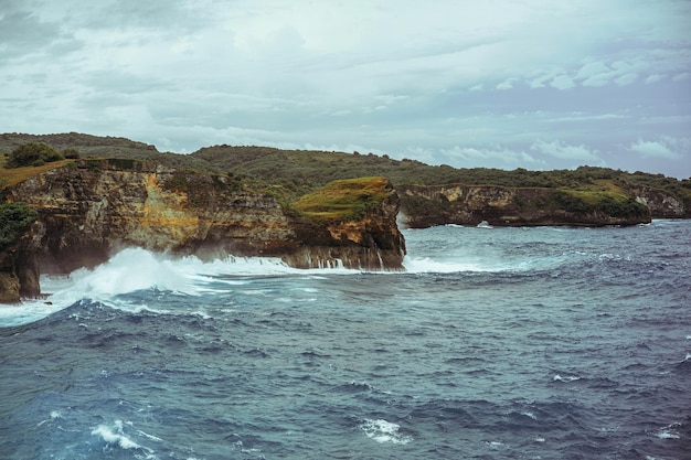 Magnificent view of unique natural rocks and cliffs formation in beautiful beach known as Angel's Billabong beach located in the east side of Nusa Penida Island, Bali, Indonesia. Aerial view.