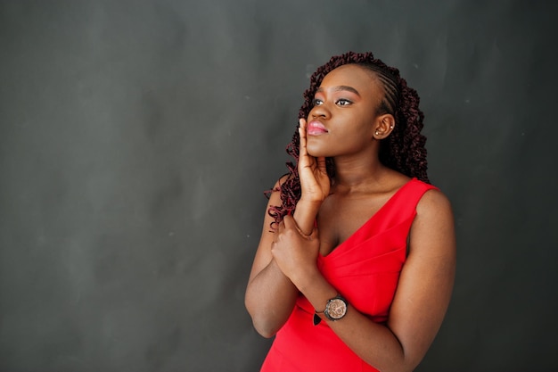 Free photo magnificent young african woman in luxurious red dress against black background beauty fashion