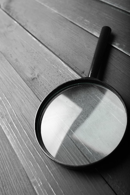 Magnifying glass or loupe on wooden table