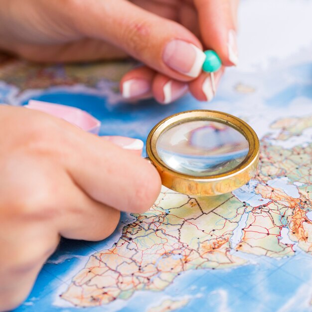 Magnifying glass and pinpoint on map