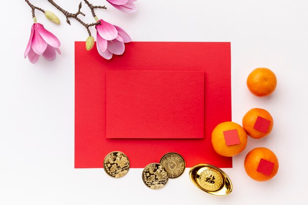Free photo magnolia and coins with card mock-up chinese new year