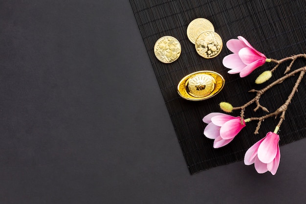 Free photo magnolia and golden coins chinese new year