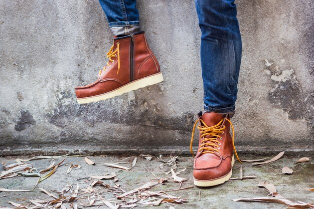 Maie foot with brown leather shoes and jeans