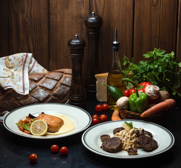 Main dishes with fish and meat and a wicker basket of vegetables