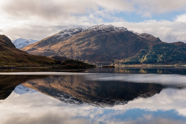 Majestic seascape view with a mountain reflection on a calm water surface in Scotland, UK