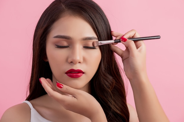 Make-up artist applying liquid eyeliner with brush