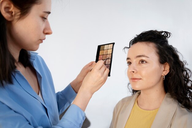 Make up artist getting model ready for photoshootin