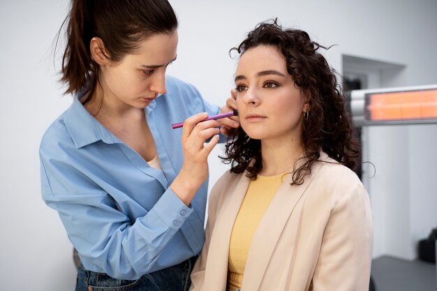 Make up artist getting model ready for photoshootin