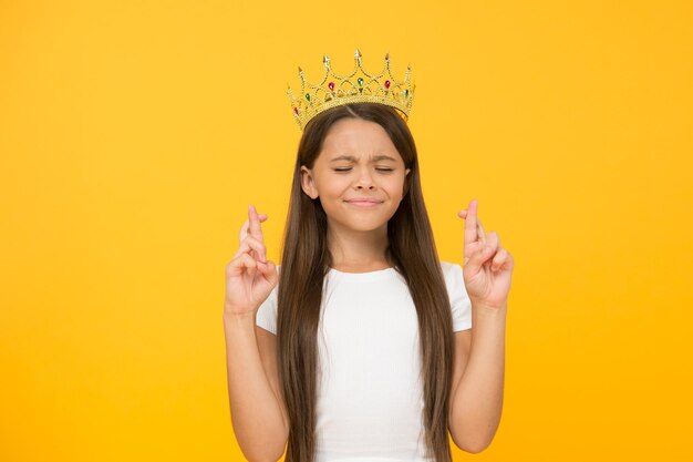 Make a wish. dreams come true. symbol of bright future. small child winner. girl is proud if herself. childhood happiness. big boss is in. share her success. selfish little girl with gold crown.
