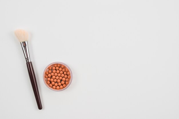 Makeup brush and blush on white background